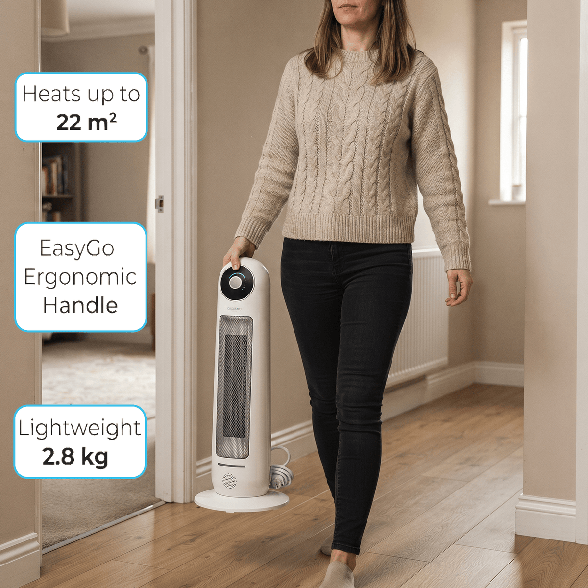 Woman carrying 2.8 kg lightweight ceramic tower heater using integrated ergonomic top handle.