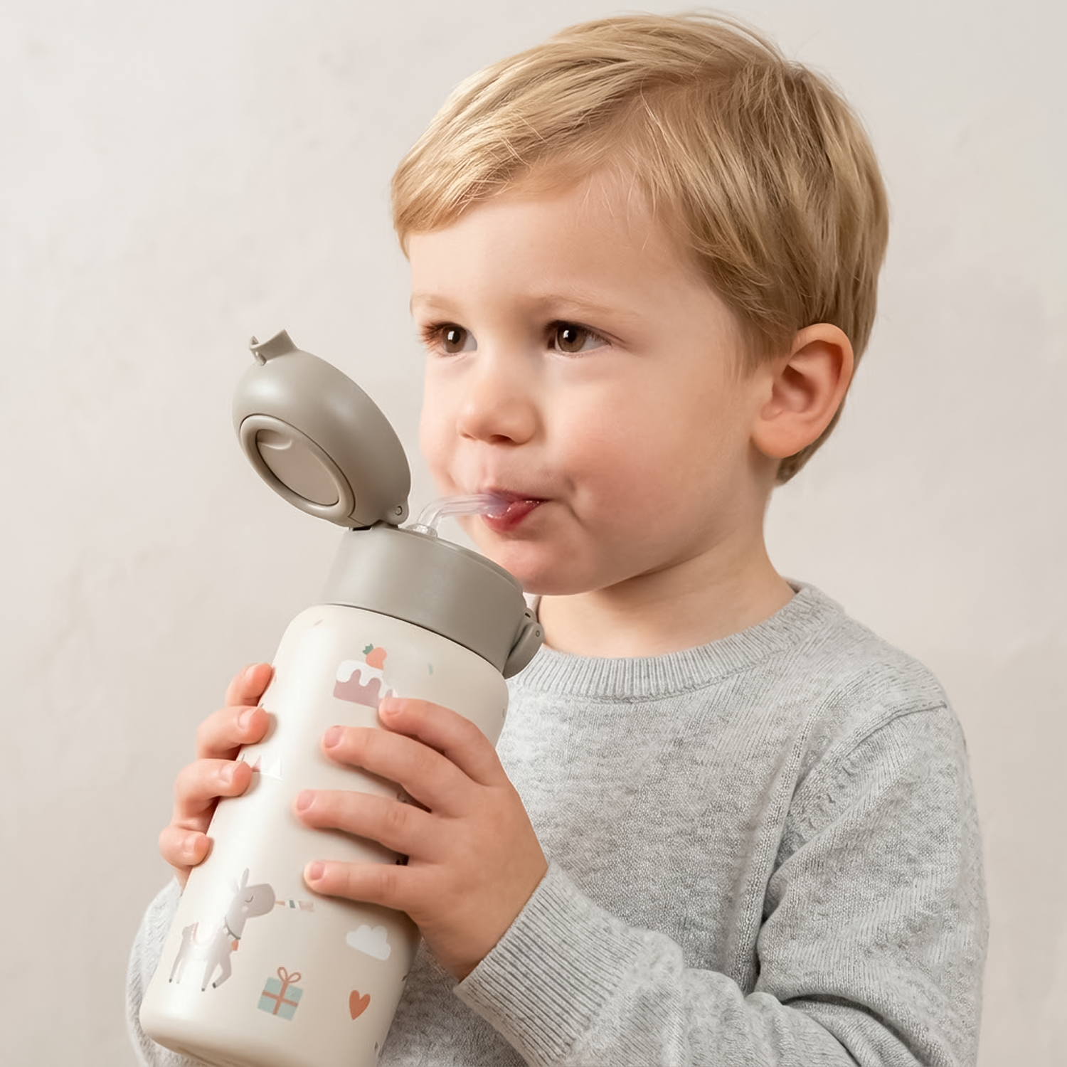 kid drinking from straw bottle