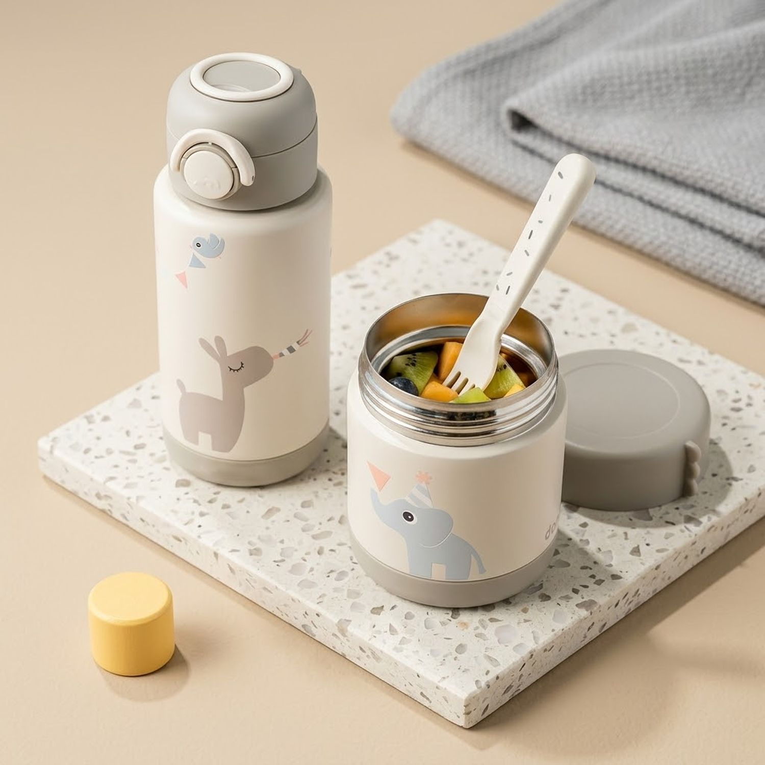 container with fruit salad and fork beside thermal water bottle