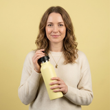 woman holding vanilla thermal water bottle